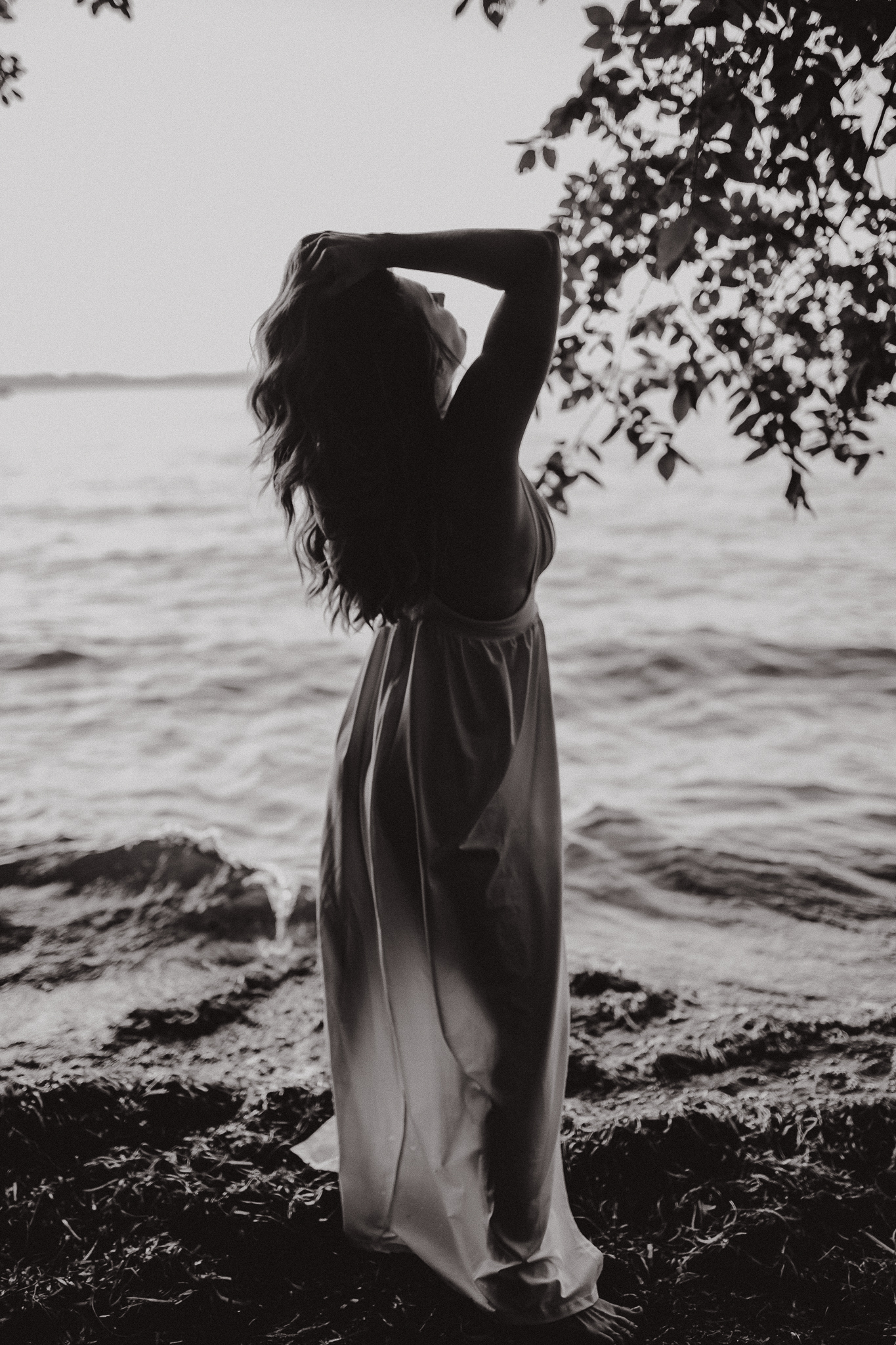 Captivating woman in an intimate lake session during a summer sunset.